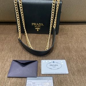 Prada Saffiano crossbody with gold chain.